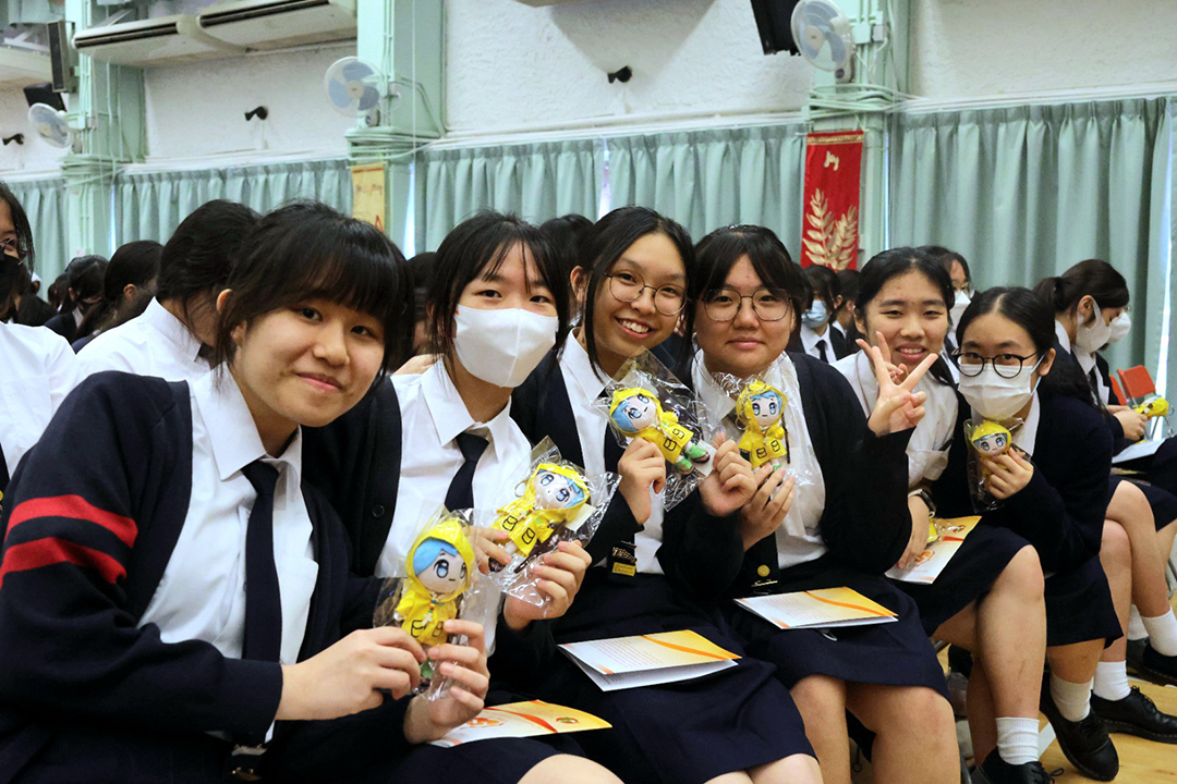 A group of girls wearing masks and standing in front of a statueDescription automatically generated