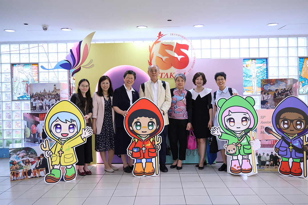 A group of girls wearing masks and standing in front of a statueDescription automatically generated