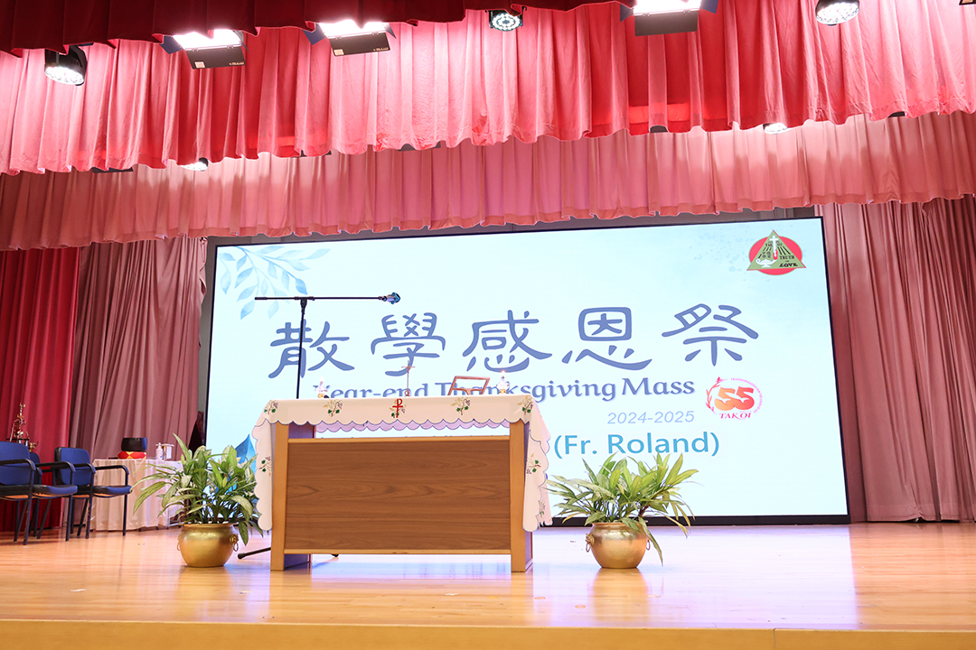 A person standing in front of a bannerDescription automatically generated