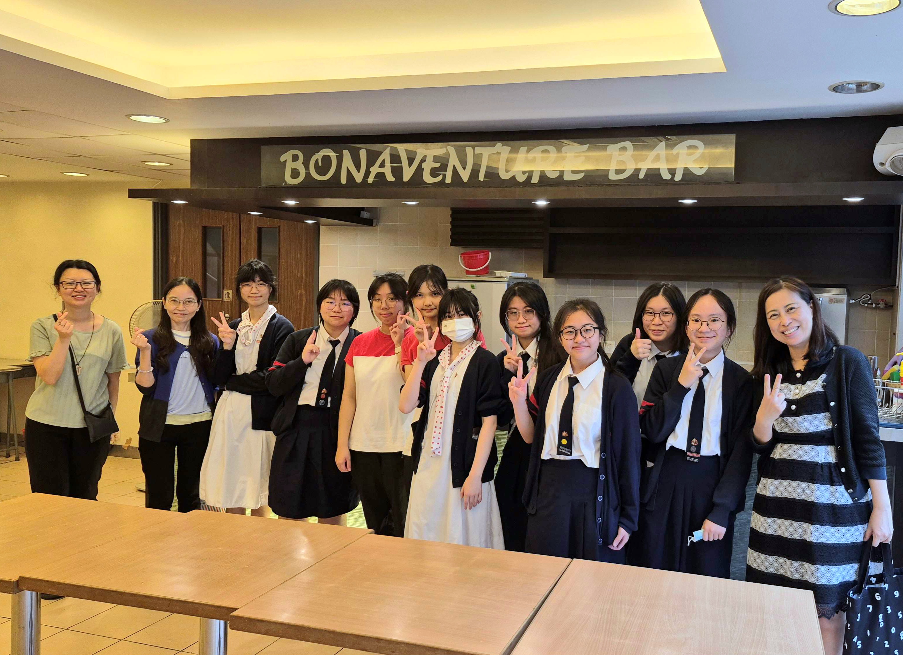 A group of people standing in front of a statueDescription automatically generated