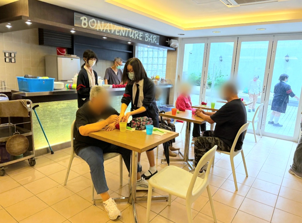 A group of girls wearing masks and standing in front of a statueDescription automatically generated