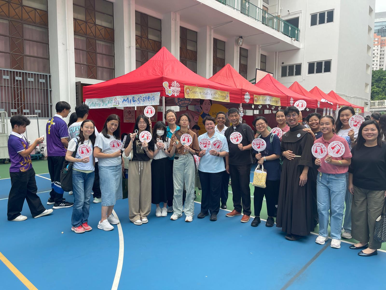 A group of girls wearing masks and standing in front of a statueDescription automatically generated