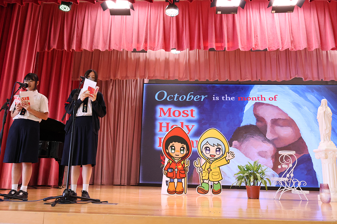 A person standing in front of a bannerDescription automatically generated