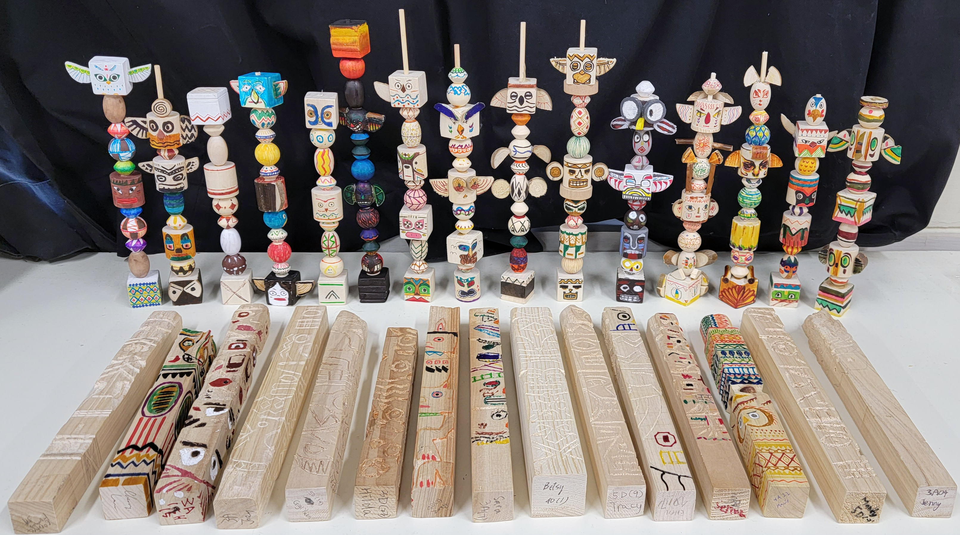 A group of wooden totemsDescription automatically generated