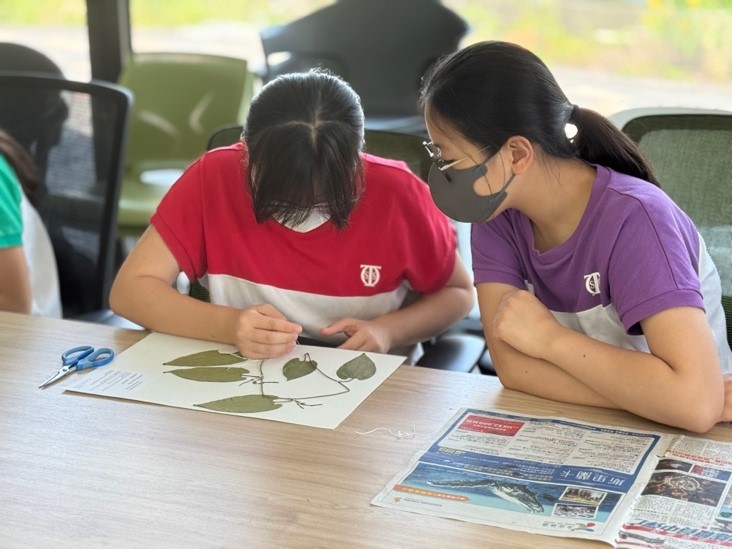 A group of people wearing masks in a classroomDescription automatically generated